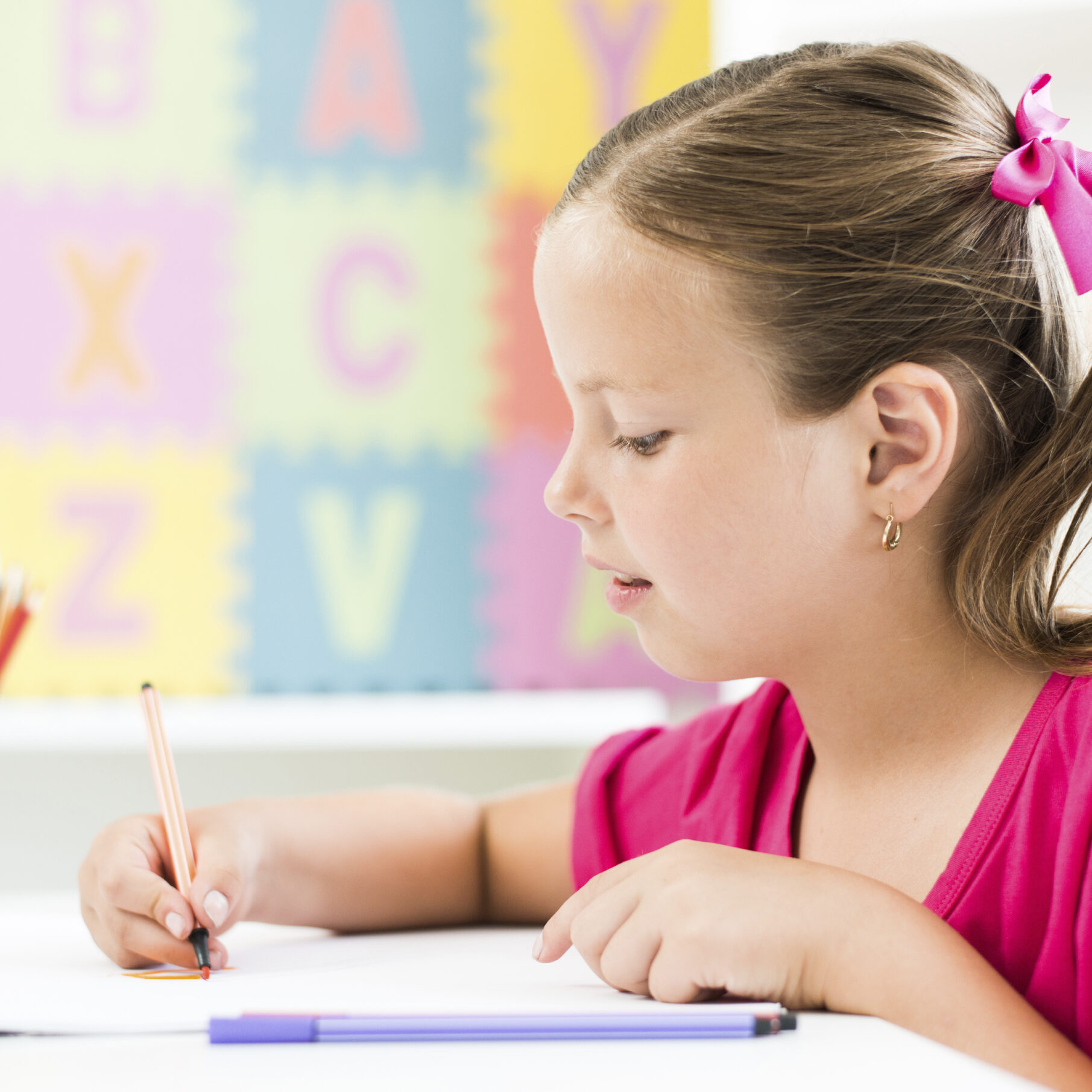 Little girl learning to write letters